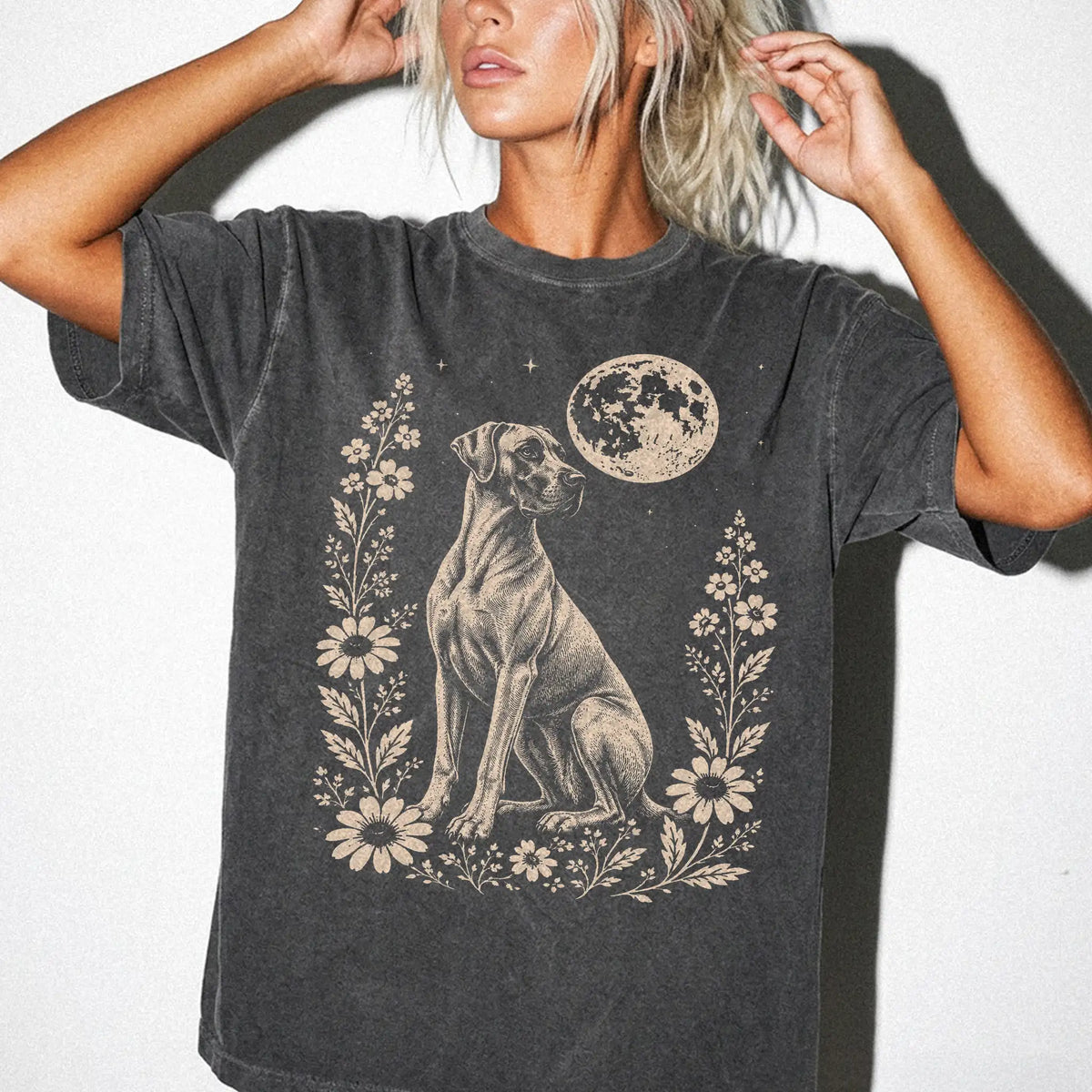 Model wearing a Pepper Comfort Colors® T-shirt featuring Great Dane framed by flowers beneath the moon