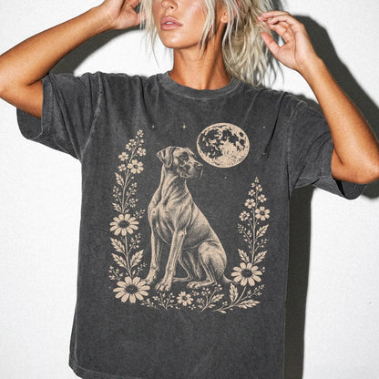 Model wearing a Pepper Comfort Colors® T-shirt featuring Great Dane framed by flowers beneath the moon