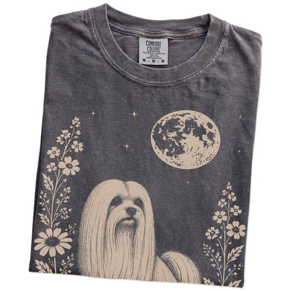 Folded Pepper Comfort Colors® T-shirt showing Maltese framed by flowers beneath the moon