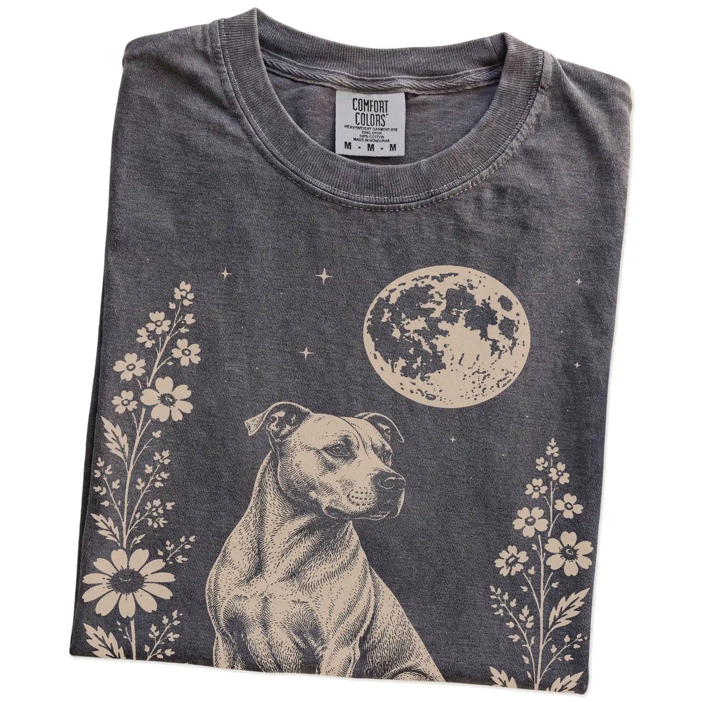 Folded Pepper Comfort Colors® T-shirt showing Pitbull framed by flowers beneath the moon