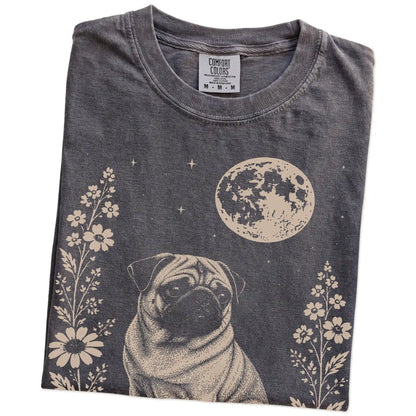 Folded Pepper Comfort Colors® T-shirt showing Pug framed by flowers beneath the moon