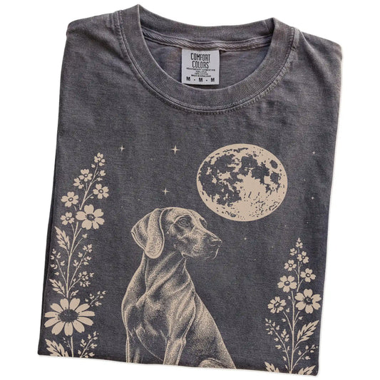 Folded Pepper Comfort Colors® T-shirt showing Weimaraner framed by flowers beneath the moon