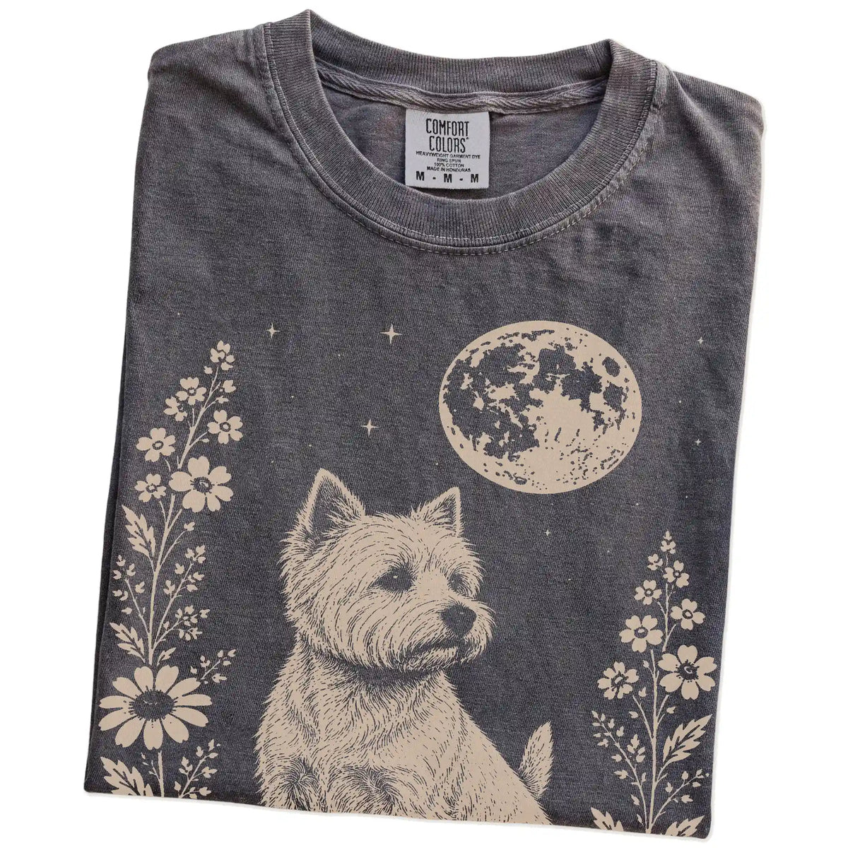 Folded Pepper Comfort Colors® T-shirt showing Westie framed by flowers beneath the moon