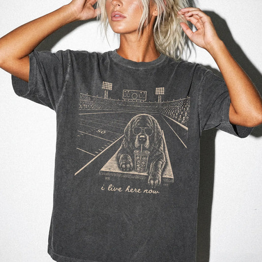 Model wearing a Pepper Comfort Colors® T-shirt featuring Newfie ready for football and tailgate season