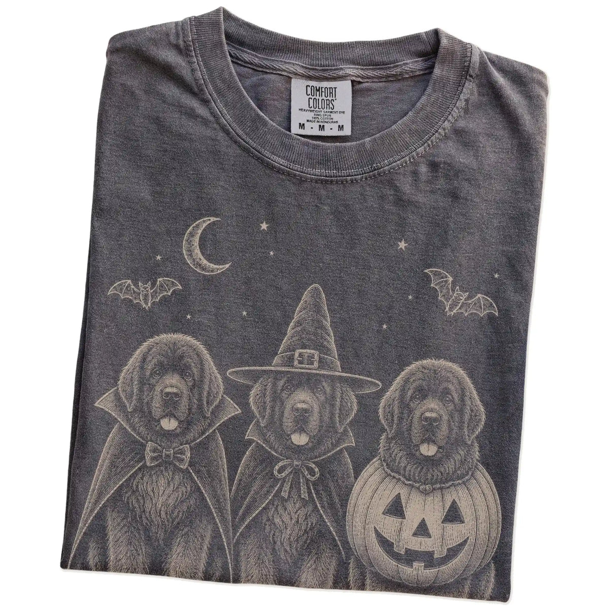 Folded Pepper Comfort Colors® T-shirt showing three Newfie dogs dressed for Halloween beneath bats and a crescent moon