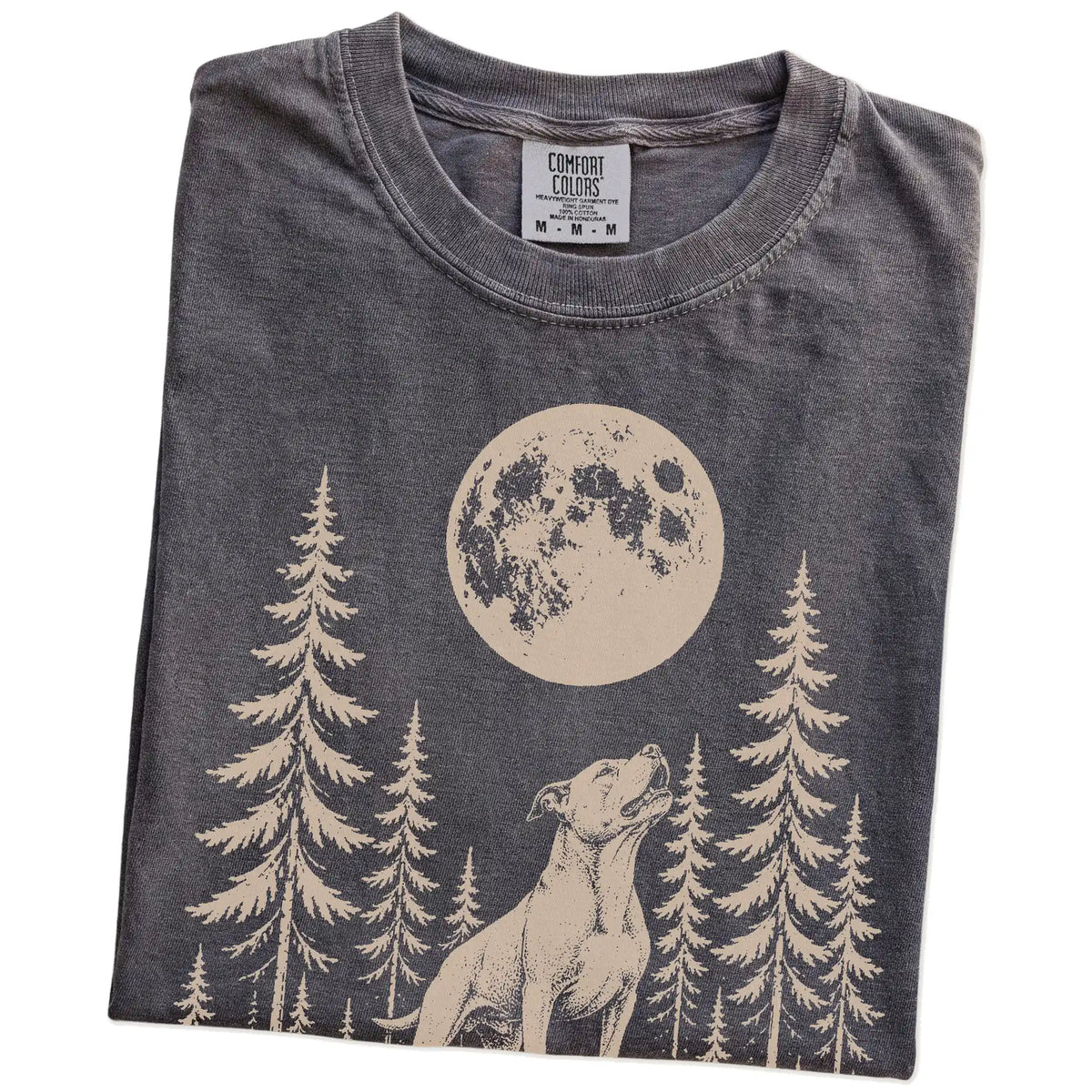 Folded Pepper Comfort Colors® T-shirt showing a Pitbull howling beneath the moon and pine trees