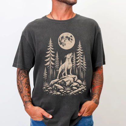 Model wearing a Pepper Comfort Colors® T-shirt with a Pitbull howling beneath the moon and pine trees