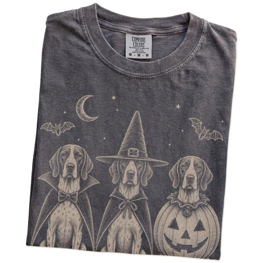 Folded Pepper Comfort Colors® T-shirt showing three Pointer dogs dressed for Halloween beneath bats and a crescent moon