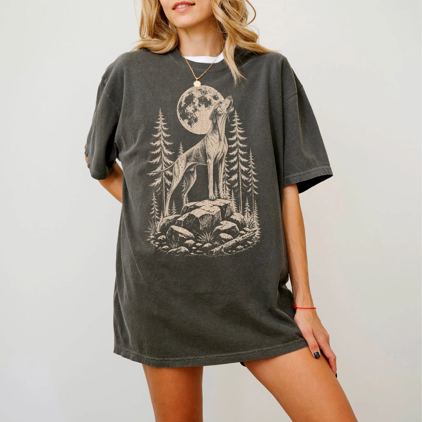 Model wearing a Pepper Comfort Colors® T-shirt with a Pointer howling beneath the moon and pine trees