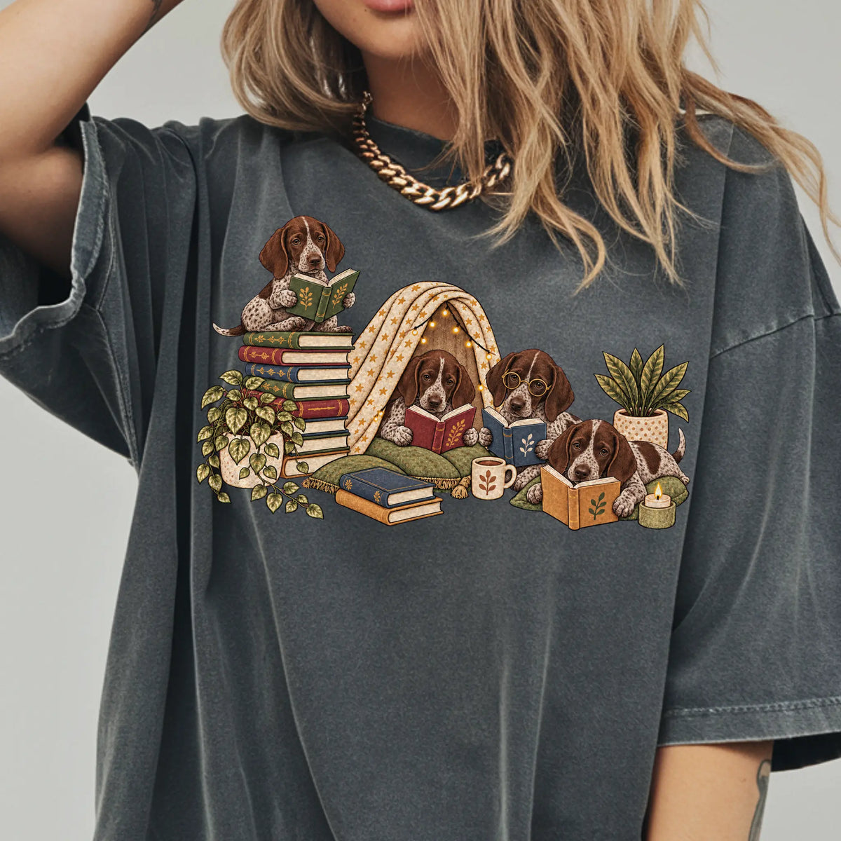 Pointer puppies reading books in a cozy blanket fort on a Pepper T-shirt worn by a model