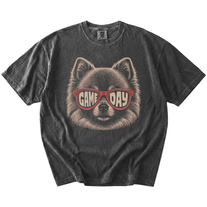 Pomeranian wearing red Game Day sunglasses on a Pepper Comfort Colors® T-shirt