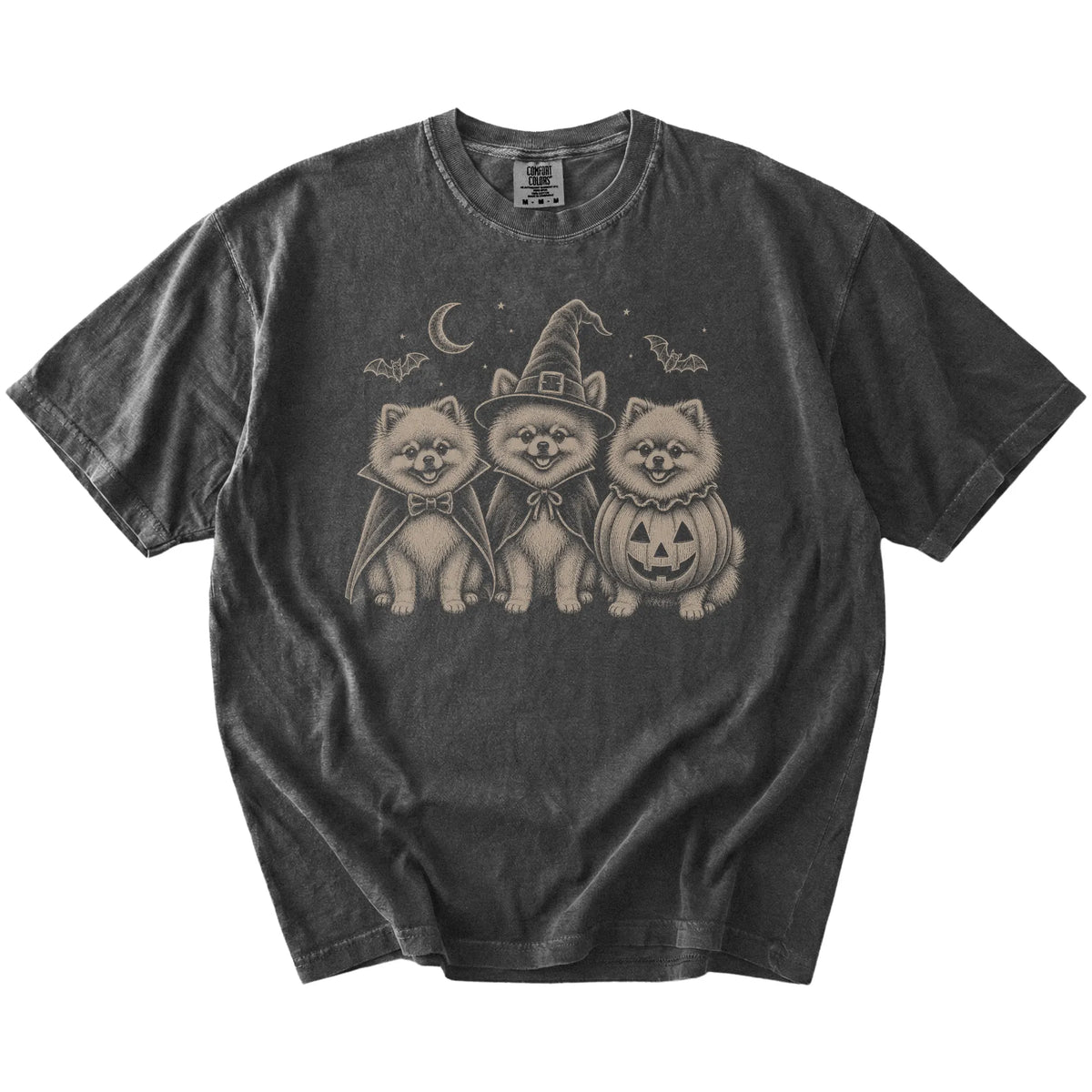 Three Pomeranian dogs dressed for Halloween beneath bats and a crescent moon on a Pepper Comfort Colors® T-shirt