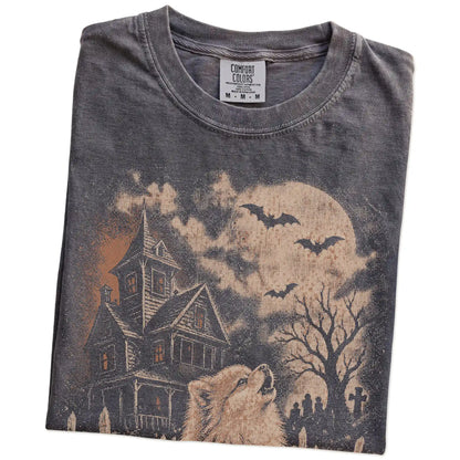 Folded Pepper Comfort Colors® T-shirt showing Pomeranian in a vintage haunted-house scene