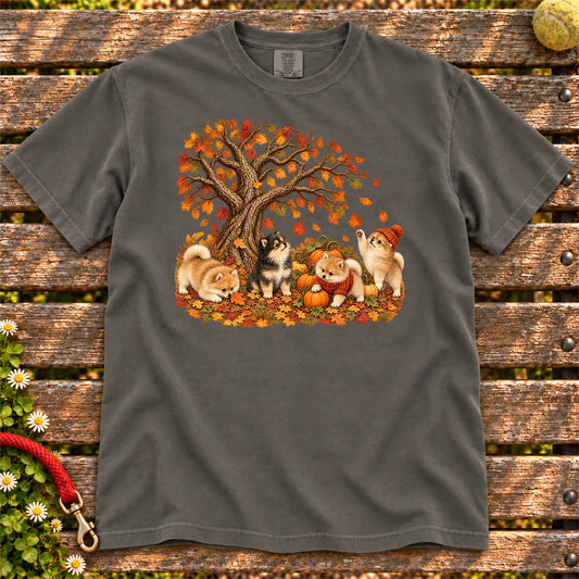 Four Pomeranian puppies with pumpkins beneath an autumn tree on a Pepper garment-dyed T-shirt