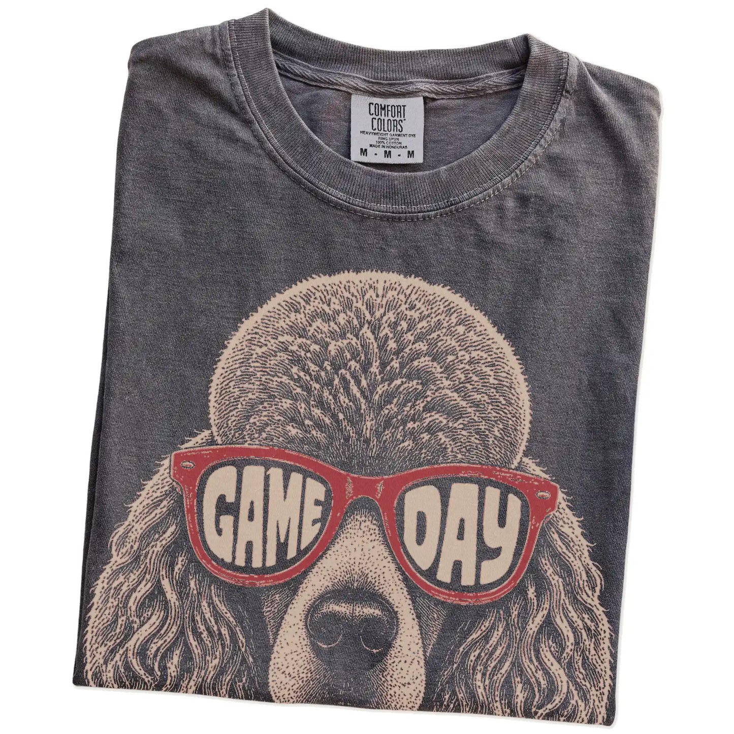 Folded Pepper Comfort Colors® T-shirt showing poodle wearing red game day sunglasses