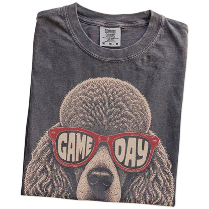 Folded Pepper Comfort Colors® T-shirt showing poodle wearing red game day sunglasses