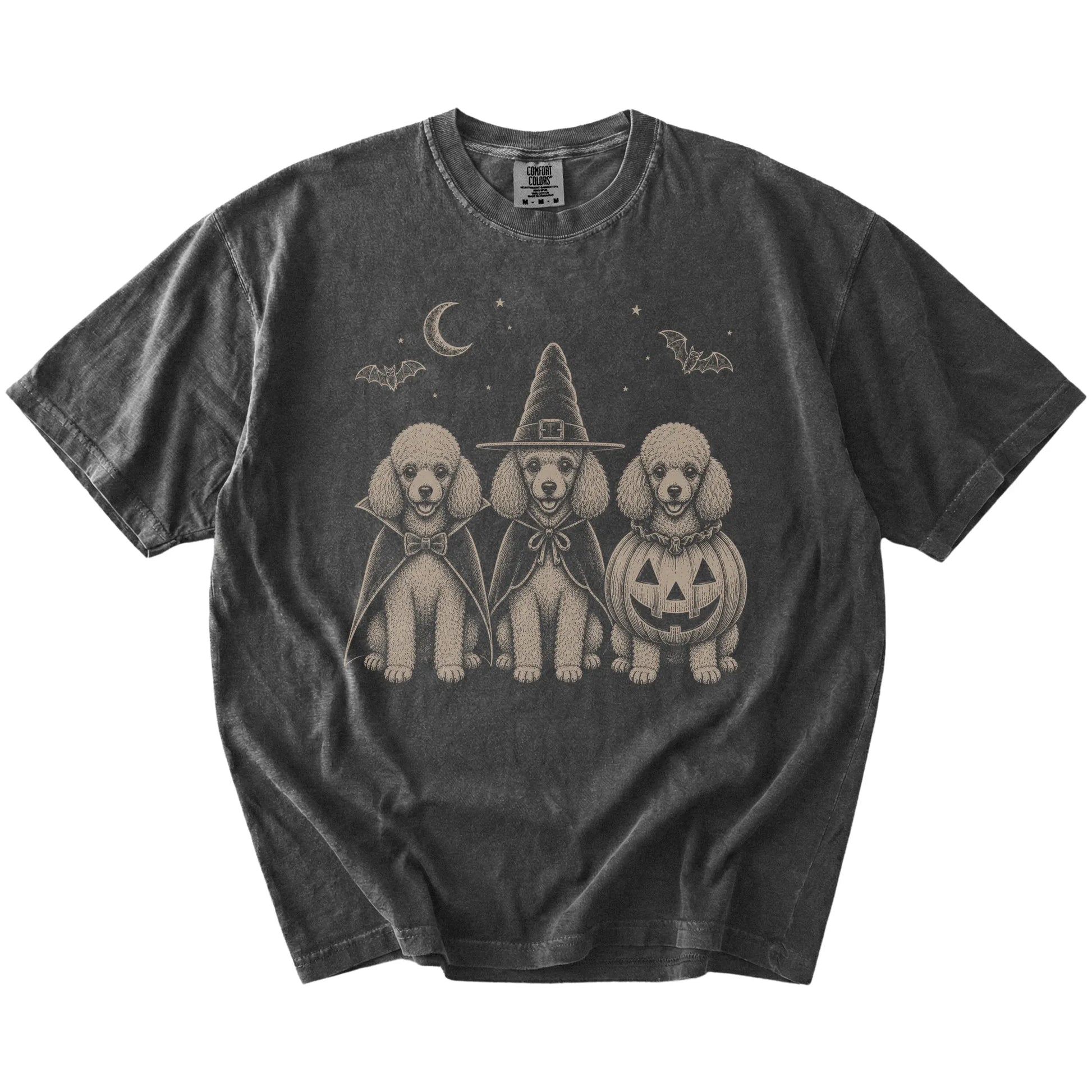 Three Poodle dogs dressed for Halloween beneath bats and a crescent moon on a Pepper Comfort Colors® T-shirt