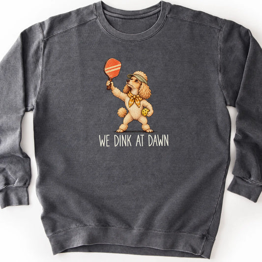 Poodle with a pickleball paddle and ball on a Pepper Comfort Colors® sweatshirt with We Dink at Dawn text