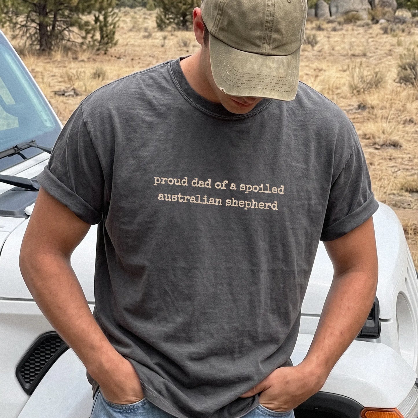 Model wearing a Pepper Comfort Colors® T-shirt with proud dad of a spoiled australian shepherd lettering