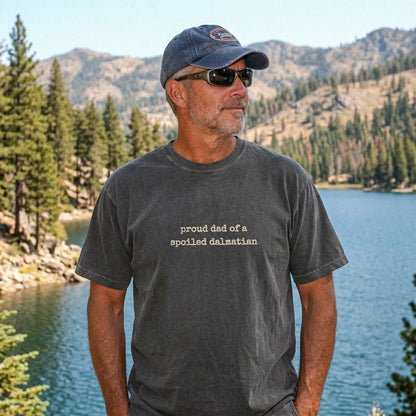 Model wearing a Pepper Comfort Colors® T-shirt with proud dad of a spoiled dalmatian lettering