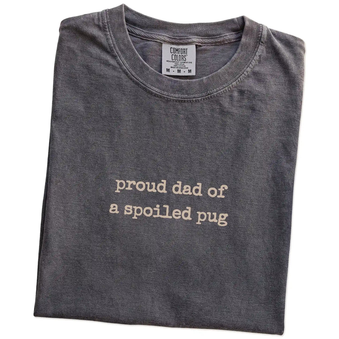 Folded Pepper Comfort Colors® T-shirt showing proud dad of a spoiled pug lettering