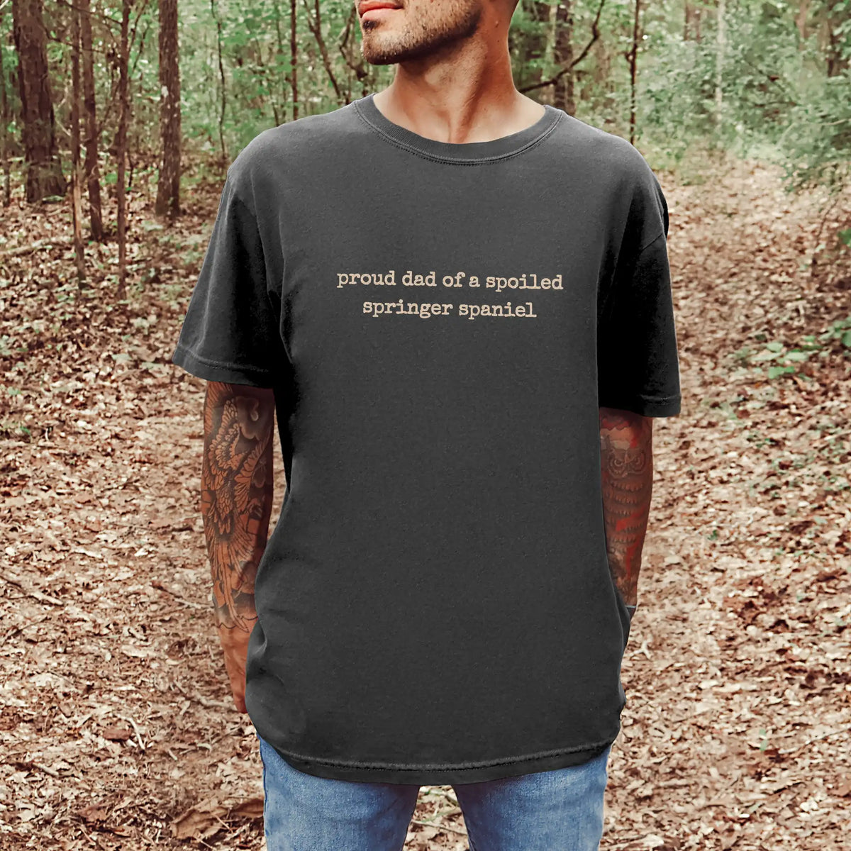 Model wearing a Pepper Comfort Colors® T-shirt with proud dad of a spoiled springer spaniel lettering