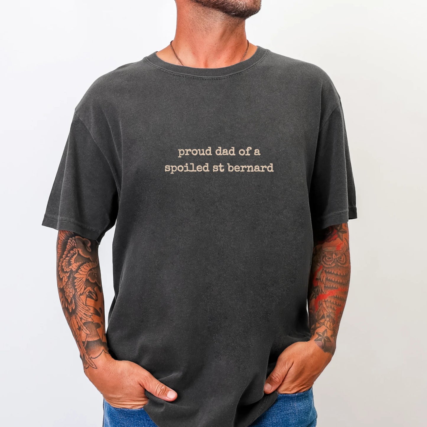 Model wearing a Pepper Comfort Colors® T-shirt with proud dad of a spoiled saint bernard lettering