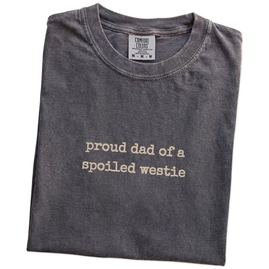 Folded Pepper Comfort Colors® T-shirt showing proud dad of a spoiled westie lettering