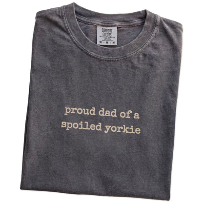 Folded Pepper Comfort Colors® T-shirt showing proud dad of a spoiled yorkie lettering