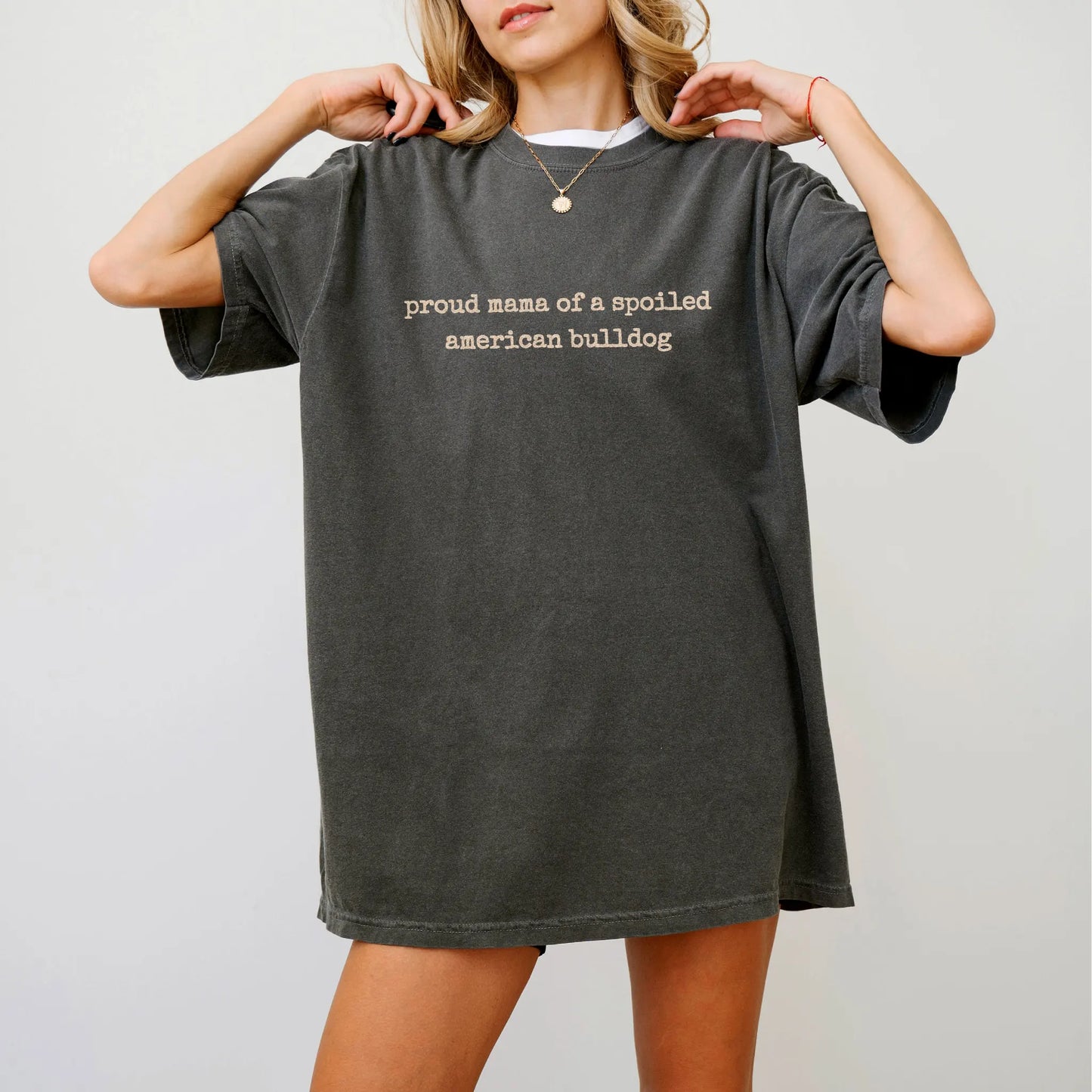 Model wearing a Pepper Comfort Colors® T-shirt featuring Proud Mama of a Spoiled American Bulldog lettering