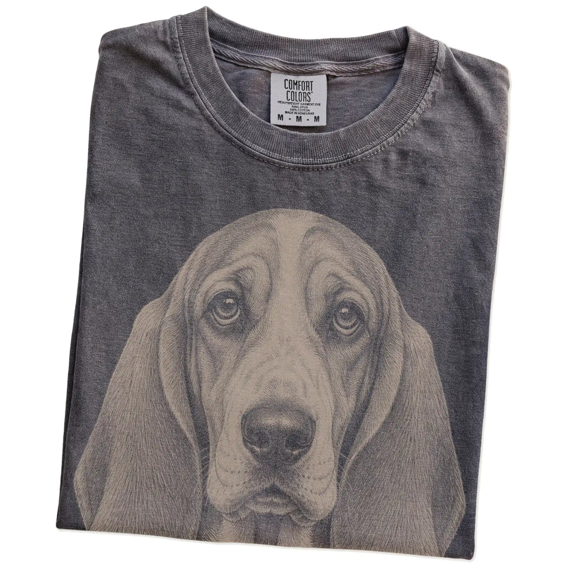 Folded Pepper Comfort Colors® T-shirt showing a realistic drawing of a Basset Hound
