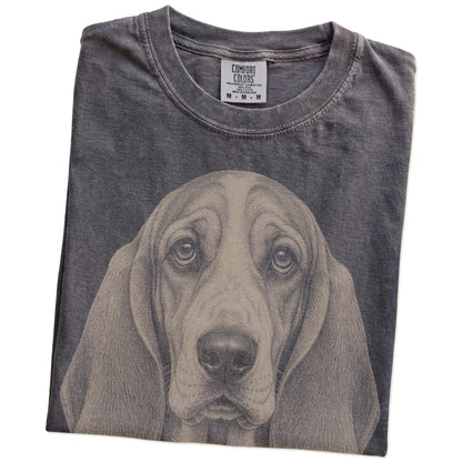 Folded Pepper Comfort Colors® T-shirt showing a realistic drawing of a Basset Hound