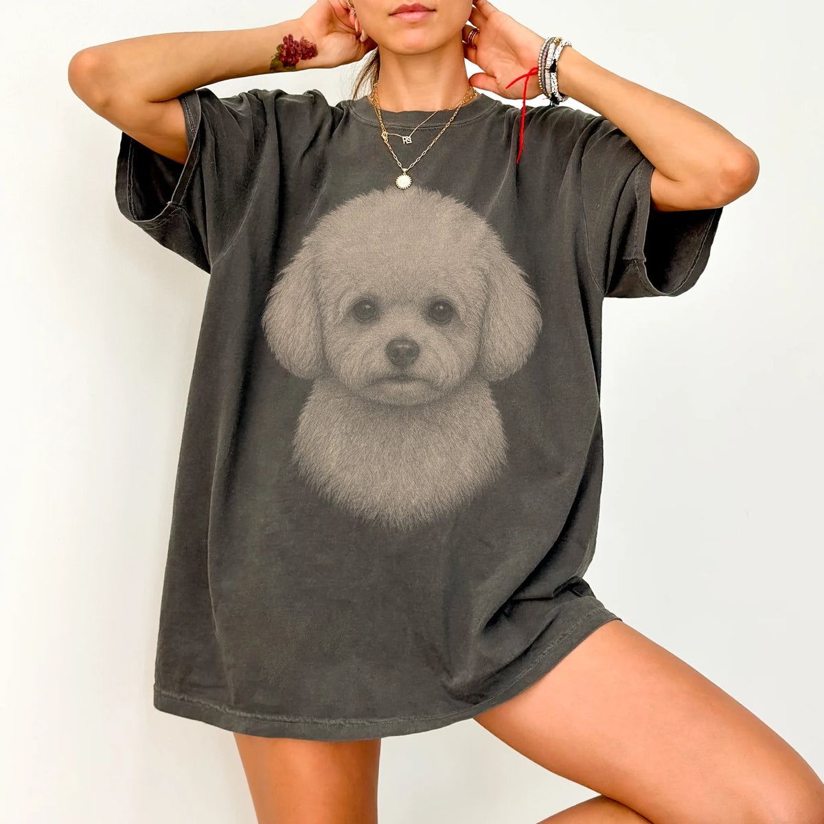 Model wearing a Pepper Comfort Colors® T-shirt with a realistic drawing of a Bichon Frise