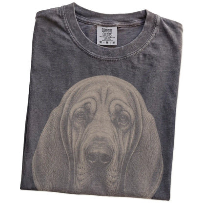 Folded Pepper Comfort Colors® T-shirt showing a realistic drawing of a Bloodhound