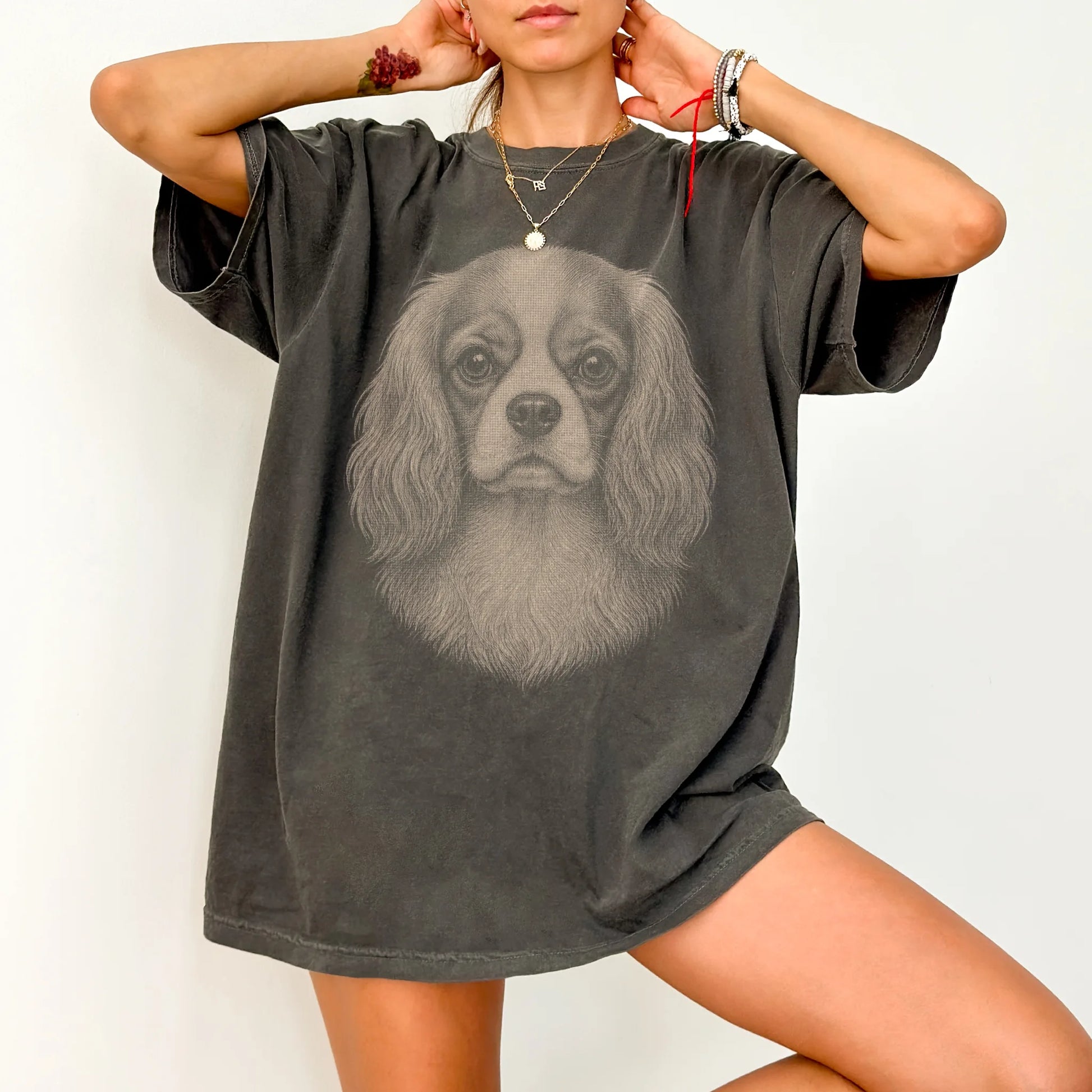 Model wearing a Pepper Comfort Colors® T-shirt with a realistic drawing of a Cavalier King Charles Spaniel