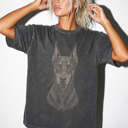 Model wearing a Pepper Comfort Colors® T-shirt with a realistic drawing of a Doberman