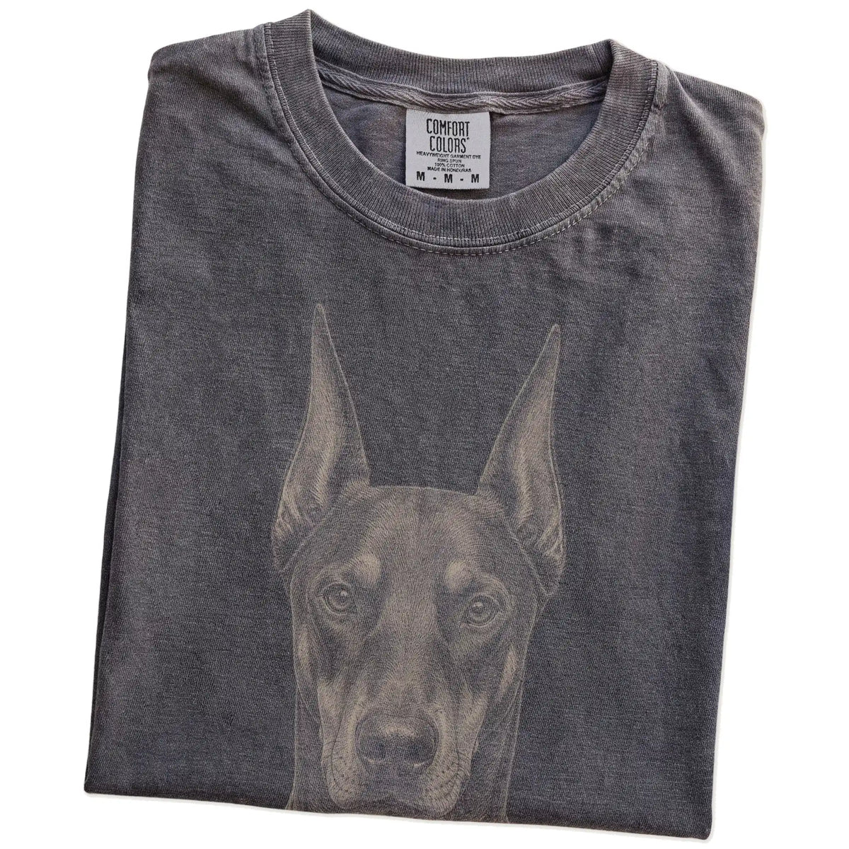 Folded Pepper Comfort Colors® T-shirt showing a realistic drawing of a Doberman