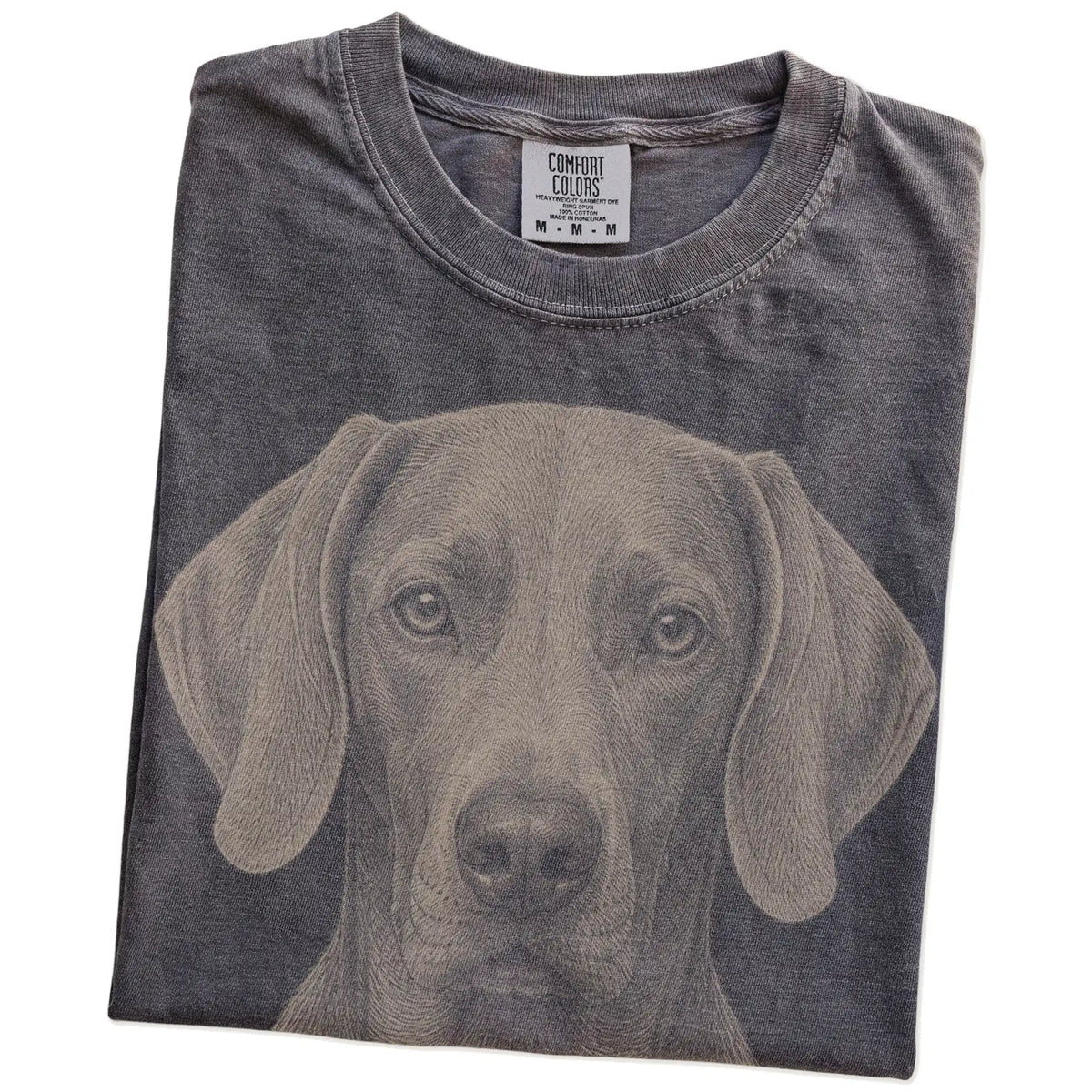 Folded Pepper Comfort Colors® T-shirt showing a realistic drawing of a Weimaraner