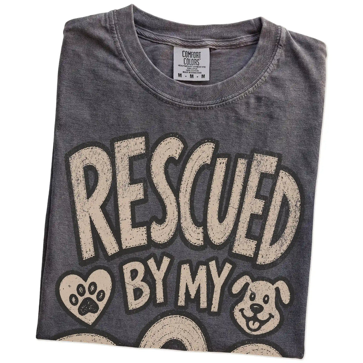 Folded Pepper Comfort Colors® T-shirt showing rescued by my dog lettering