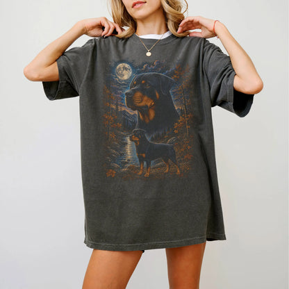 Model wearing a Pepper Comfort Colors® t-shirt featuring Rottweiler in a moonlit fall forest