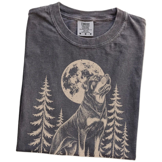 Folded Pepper Comfort Colors® T-shirt showing a Rottweiler howling beneath the moon and pine trees