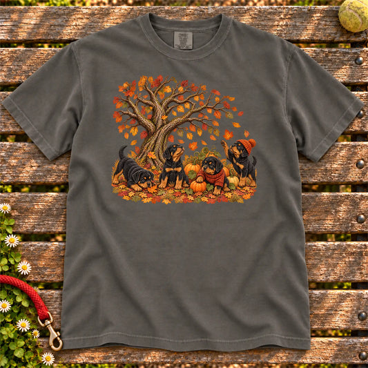 Four Rottweiler puppies with pumpkins beneath an autumn tree on a Pepper garment-dyed T-shirt