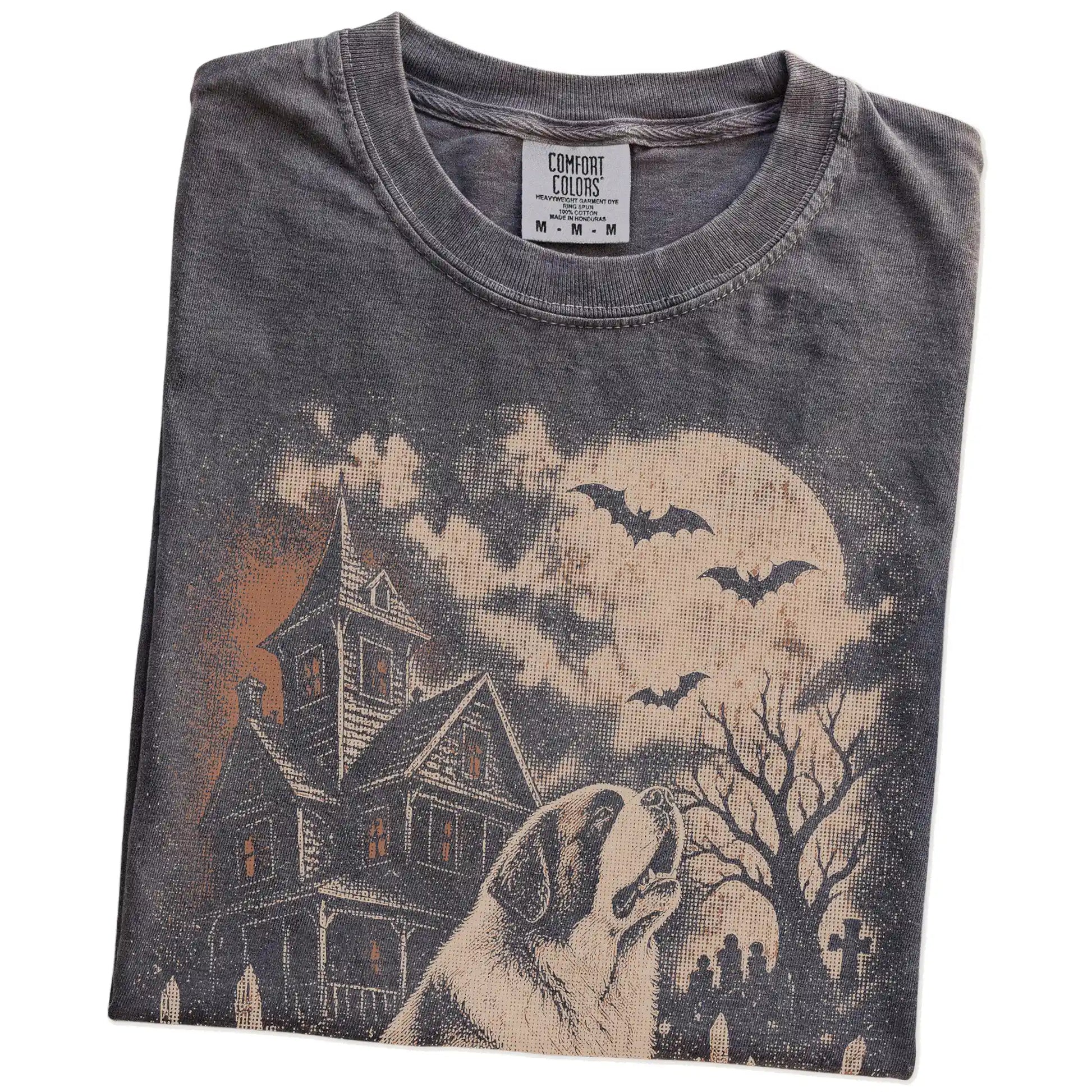 Folded Pepper Comfort Colors® T-shirt showing Saint Bernard in a vintage haunted-house scene