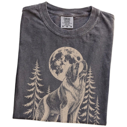 Folded Pepper Comfort Colors® T-shirt showing a Saint Bernard howling beneath the moon and pine trees