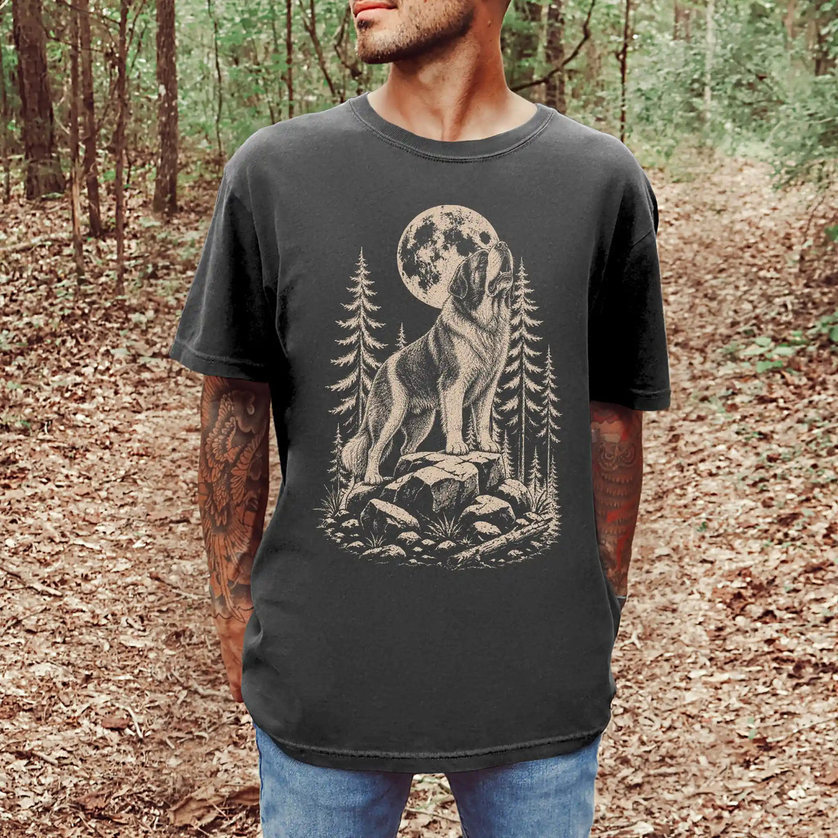 Model wearing a Pepper Comfort Colors® T-shirt with a Saint Bernard howling beneath the moon and pine trees