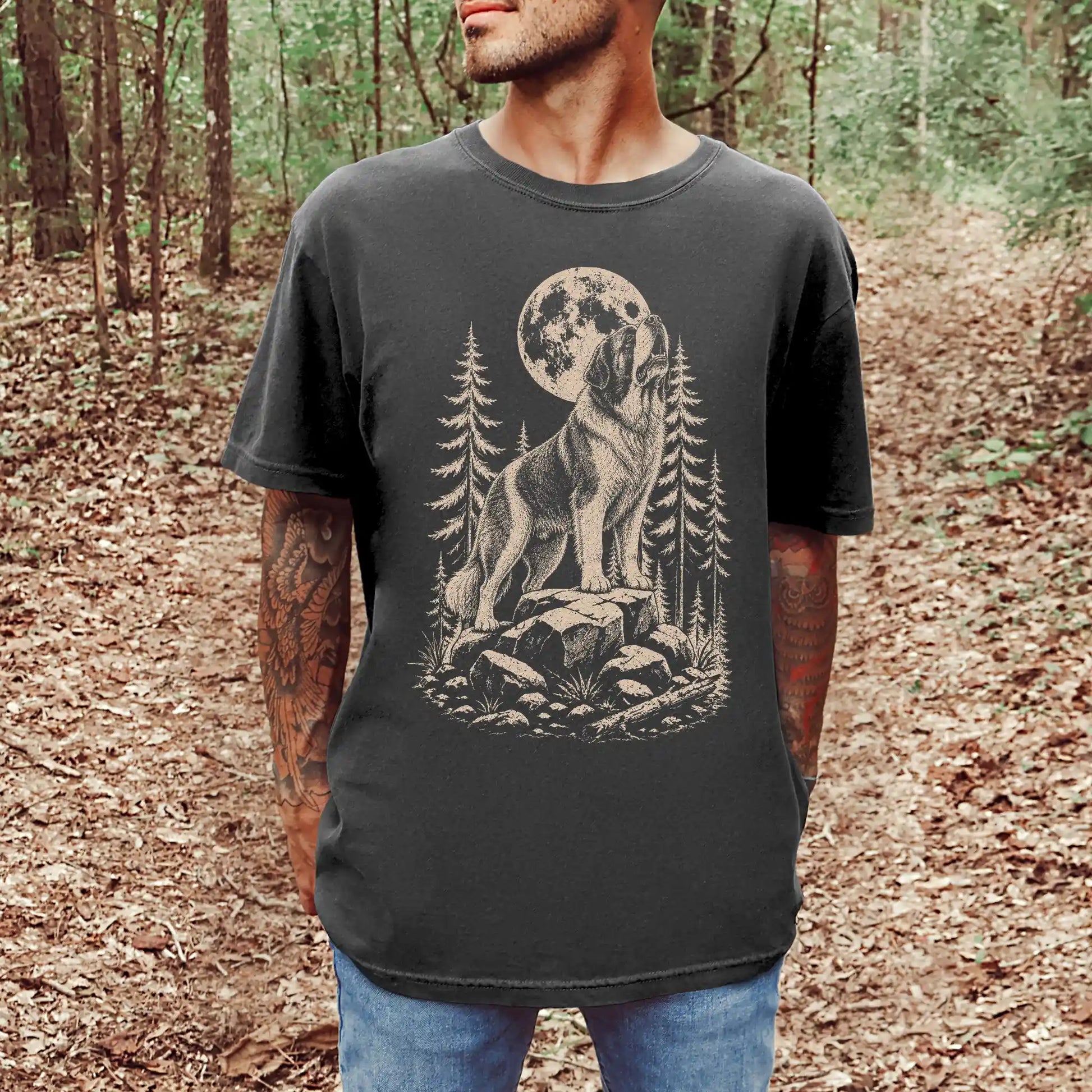 Model wearing a Pepper Comfort Colors® T-shirt with a Saint Bernard howling beneath the moon and pine trees
