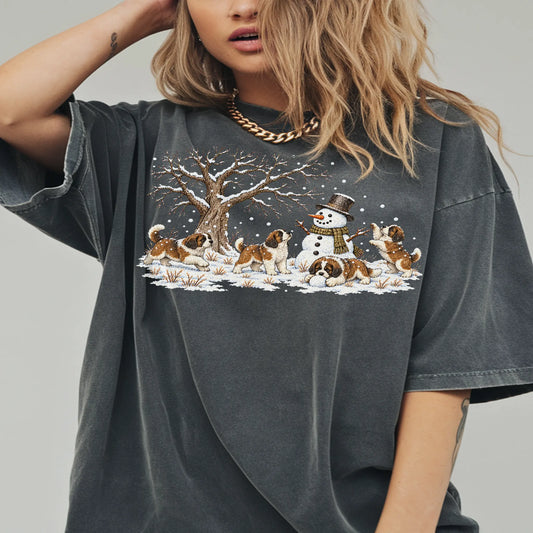 Saint Bernard puppies playing in snow with a snowman on a Pepper T-shirt worn by a model