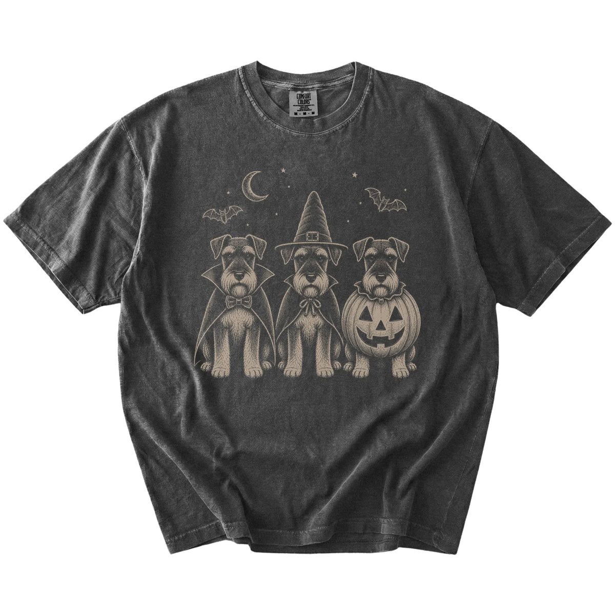 Three Schnauzer dogs dressed for Halloween beneath bats and a crescent moon on a Pepper Comfort Colors® T-shirt