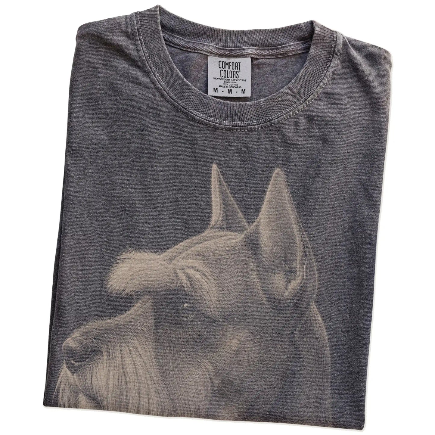 Folded Pepper Comfort Colors® T-shirt showing a detailed photographic portrait of a Schnauzer