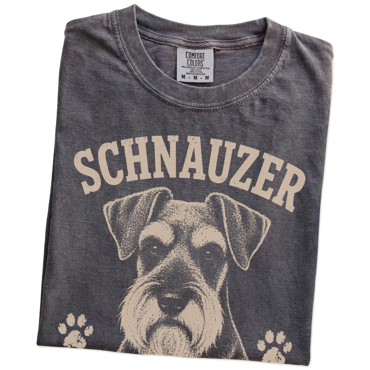 Folded Pepper Comfort Colors® T-shirt showing Schnauzer design with “Serious Brows, Questionable Decisions” lettering
